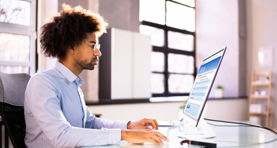 Person sits at a computer to feel out a customer success survey.